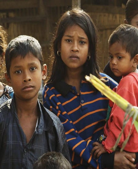 group of Burmese children looking forlornly at the camera