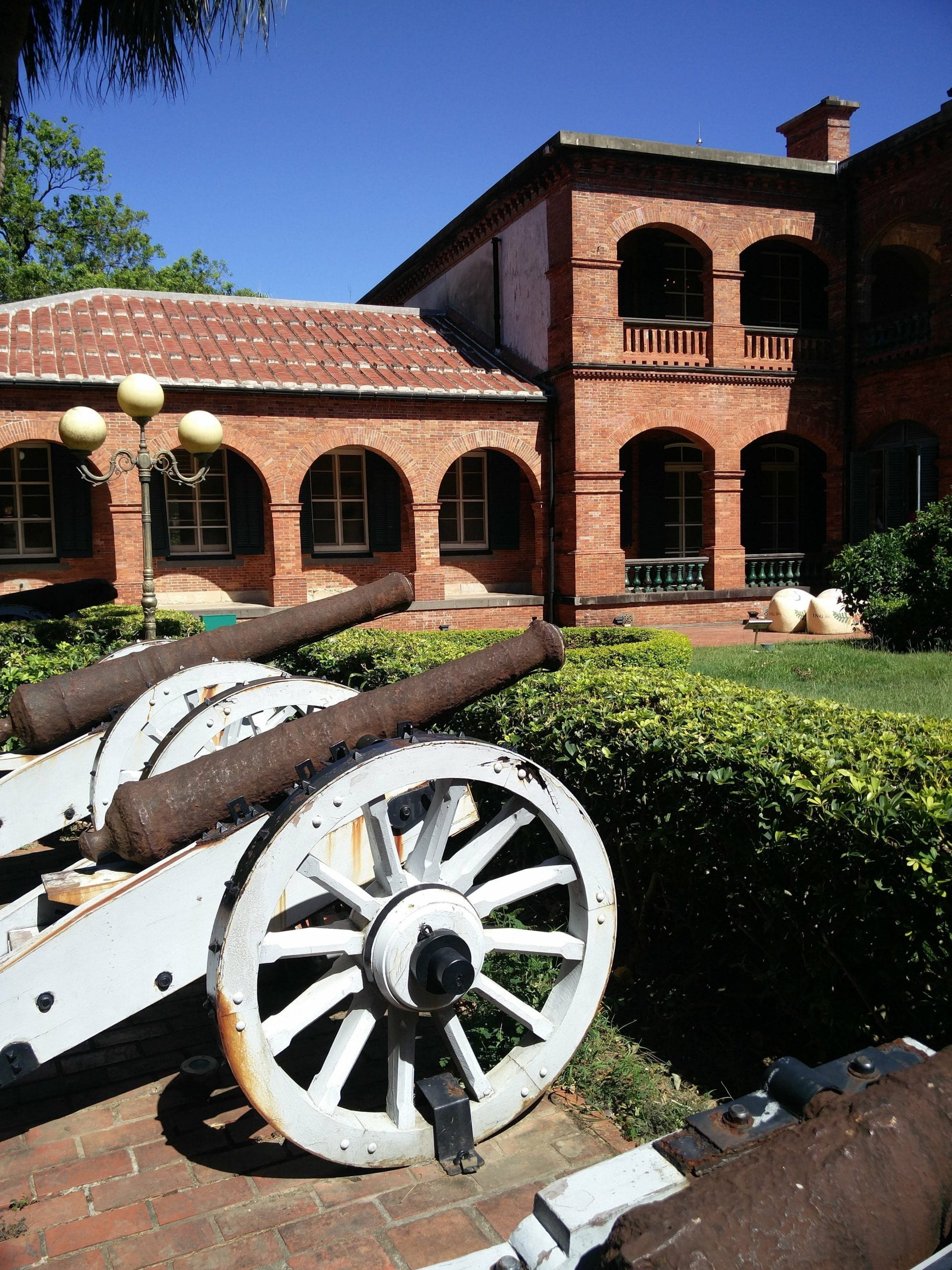 18th century cannons on display outside the former British Consulate section of Fort San Domingo
