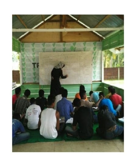person teaching to refugees in Aceh, Indonesia