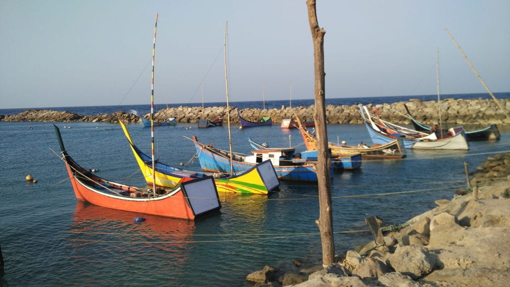 colorful boats at a pier in indonesian countryside