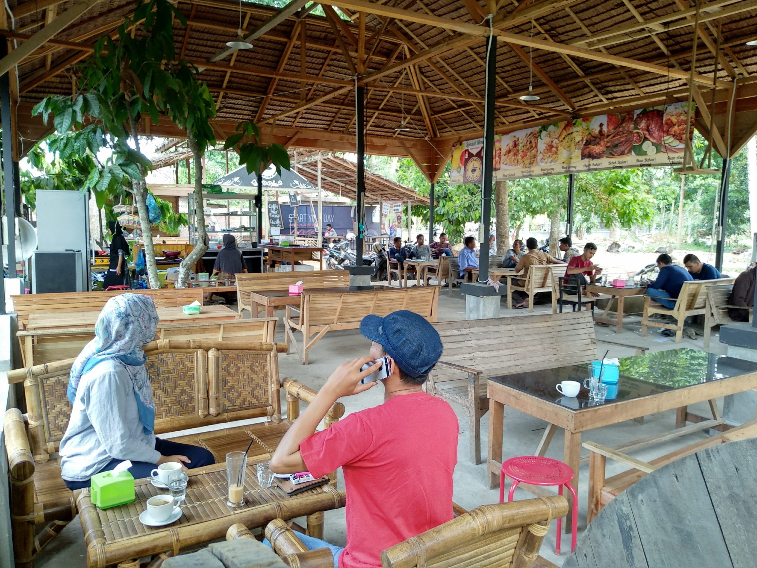 a local outdoor coffee shop with many customers