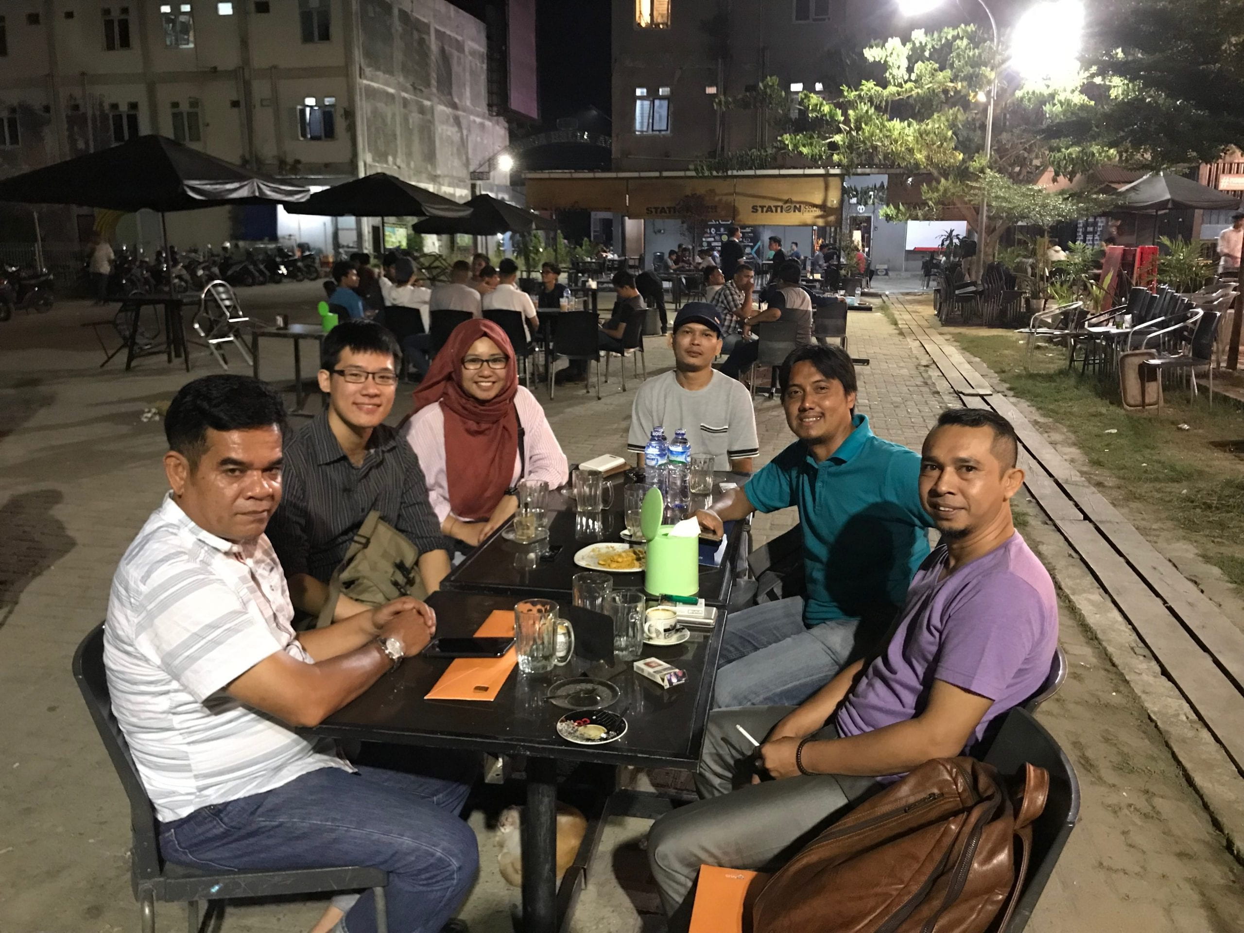 author with local indonesian human rights activists at a restaurant