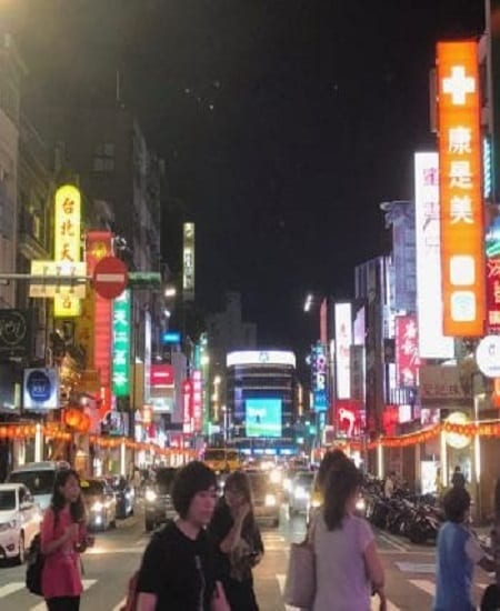 street in Taiwan at night with neon light signs