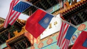 line of American and Taiwanese flags with the Chinatown arch in the background
