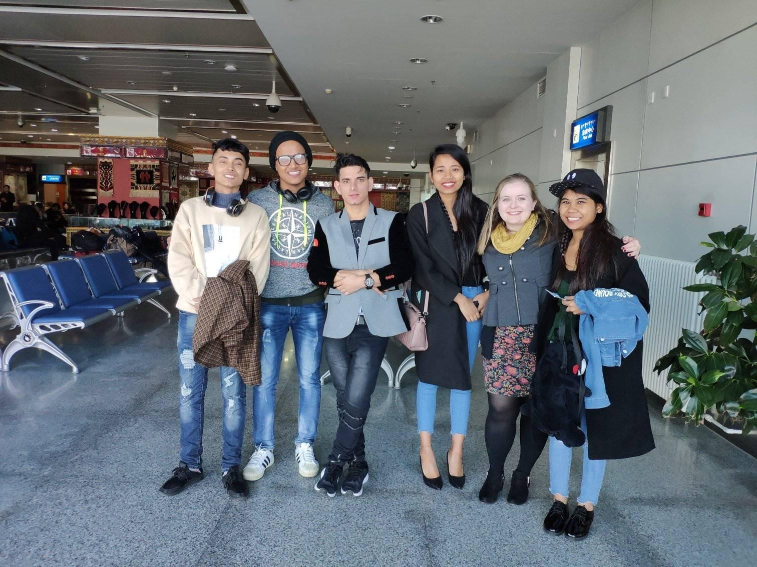 Sagar (pictured right) and Emily Hall's new Nepali friends in the airport in Lhasa, Tibet (after eating the chips)