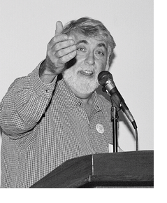 black and white photo of mark rudd speaking at an event