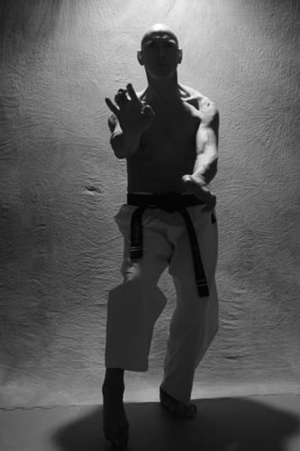 black and white photo of nestor folta in a karate pose