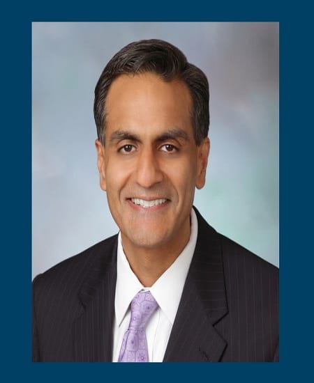 portrait of Richard Verma with a blue border