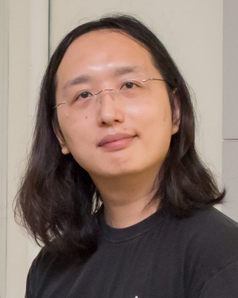 headshot of Audrey Tang in black shirt
