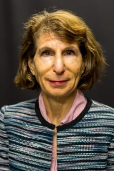 Headshot of Susan Aaronson in blue and black shirt