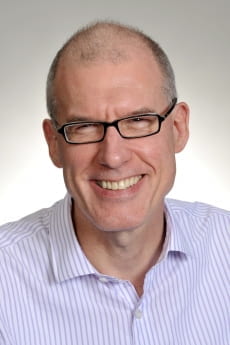 professional headshot of Donald Clarke in striped shirt
