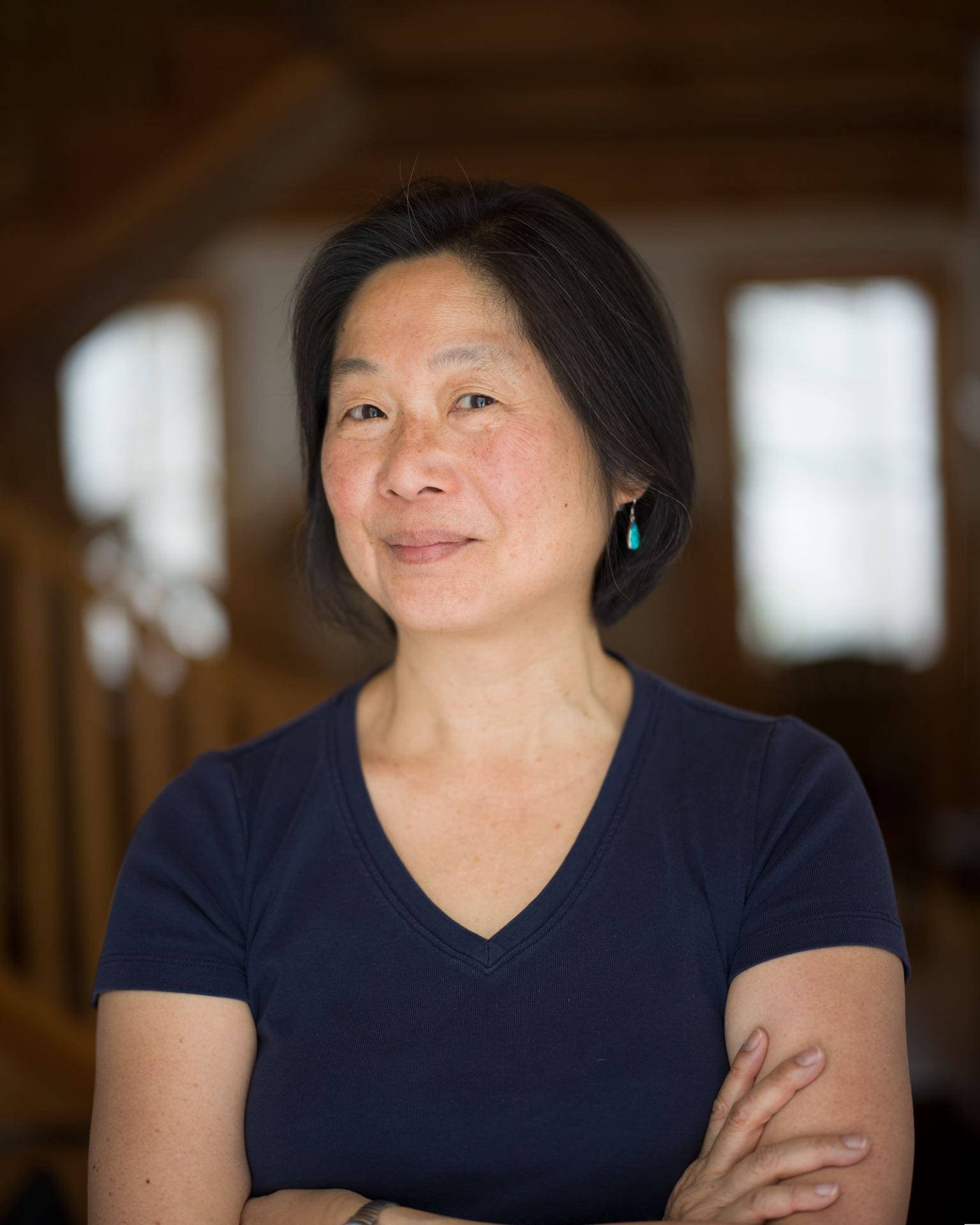 portrait of Patricia Chu, posing with arms crossed