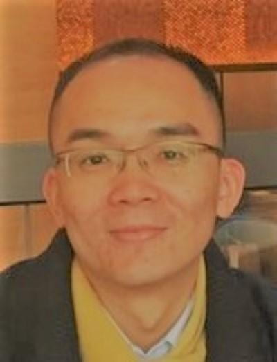 headshot of Michael Tsang in professional attire