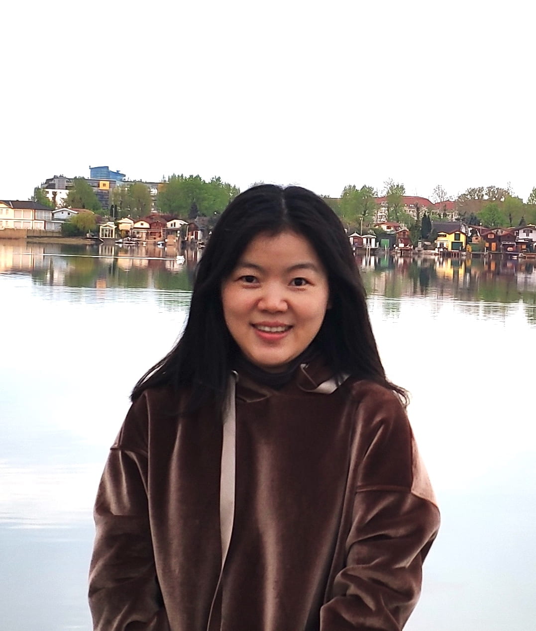 Yali Zhu posing for photo in front of a body of water